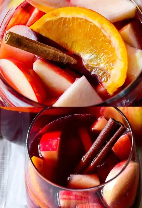 Apple cider sangria with diced apples, orange slice and cinnamon sticks in glasses