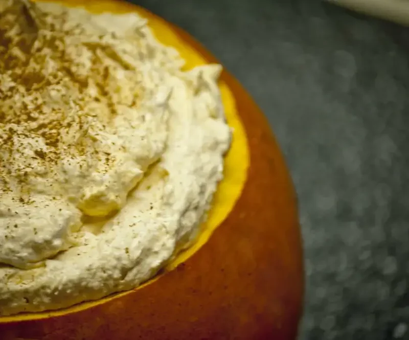 Easy pumpkin mascarpone dip in a hollowed-out mini pumpkin dusted with cinnamon