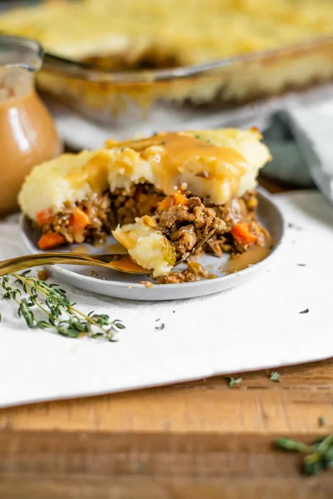 A slice of lentil shepherd's pie with a forkful taken out
