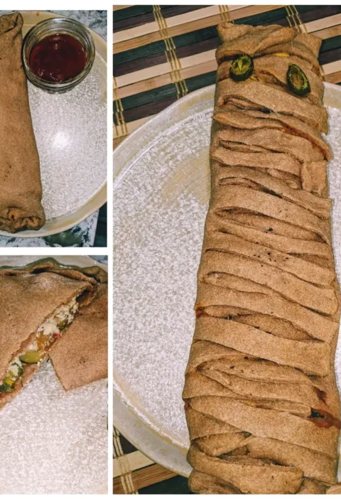 Mini mummy calzones: two whole wheat calzones with marinara and one long calzone wrapped in strips with jalapeño eyes